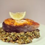 Salmon with lentils and spinach in a wholegrain mustard sauce.